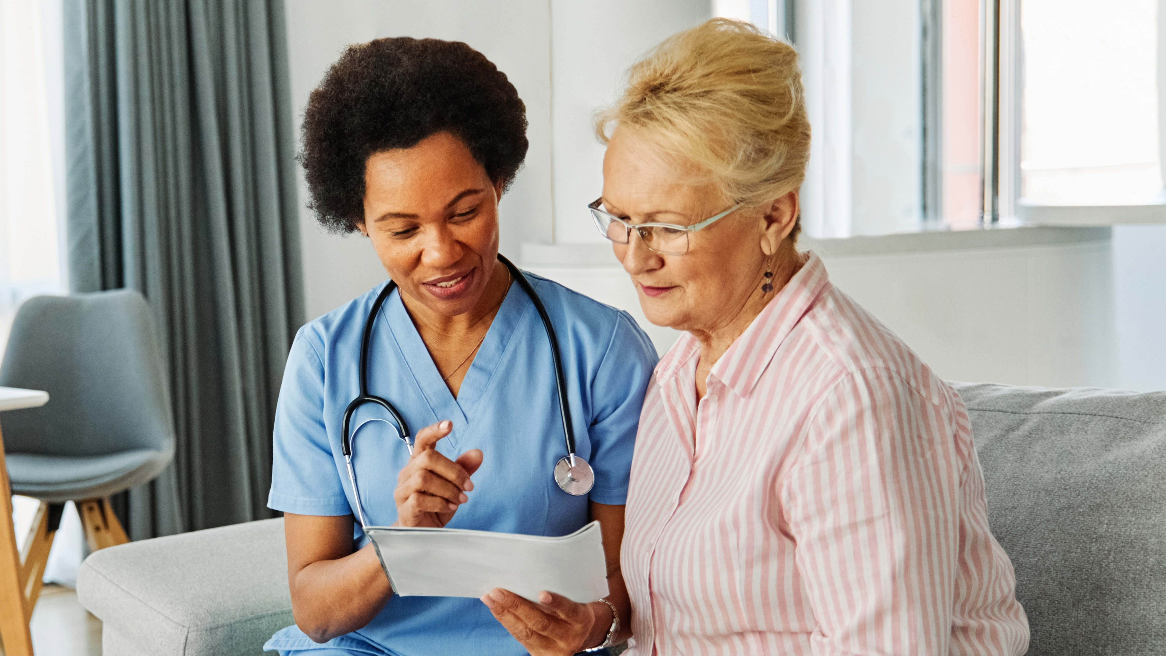 Nurse helping senior woman
